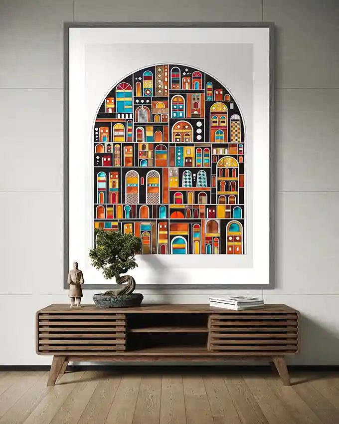 Framed colorful art print of arches on a wall above a wooden console table. by artist Yousif Ibrahim, in UAE