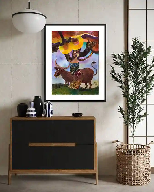 Framed "Field of Abundance" colorful art print displayed above black sideboard with decorative vases and woven basket.