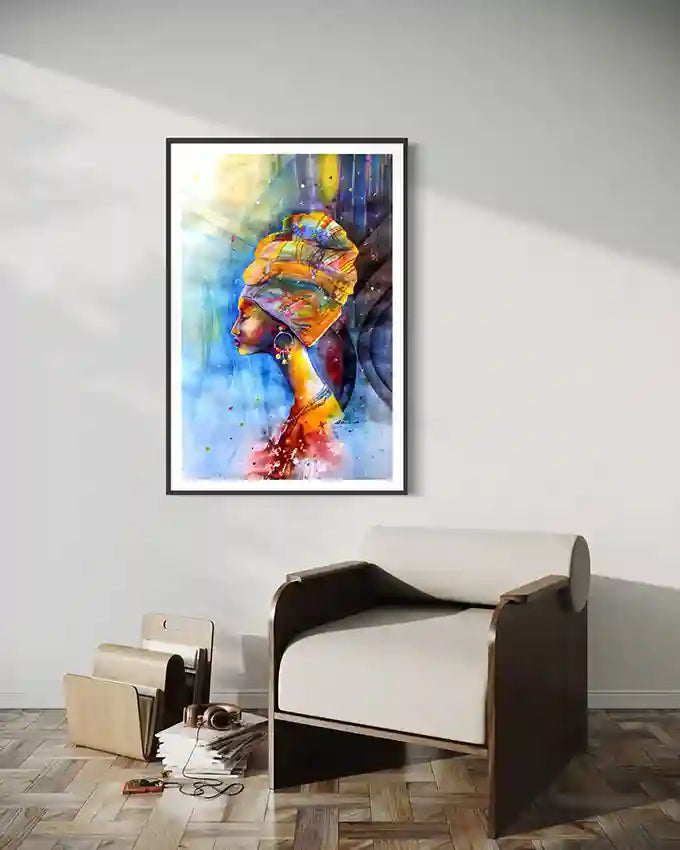 framed Colorful art print of African woman in headscarf by Galal Yousif, on a wall above a modern chair. UAE.