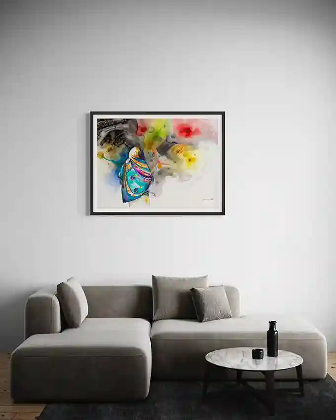 Colorful Framed art print by Sudanese Artist Galal Yousif on a wall above a gray sofa in a living room. UAe