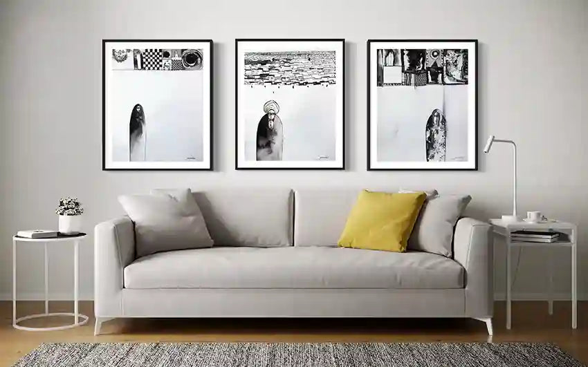 Contemporary gallery wall with black and white artworks by Abushariaa Ahmed in minimalist living room with white sofa
