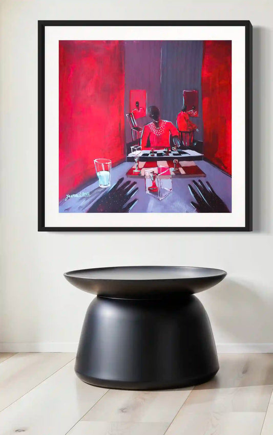 Framed art print "The Dice Player" by Yasmeen Abdullah displayed above sculptural black side table in minimalist interior
