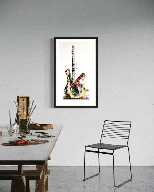 Guitar by Gungalito framed print in artist studio - colorful watercolor guitar art above workspace with paint supplies