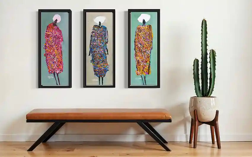 Hani Khalil Sufi series three vertical art prints as triptych in black frames above modern bench with cactus