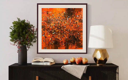 The Harvest Dance art print by Omer Kamal displayed in brown frame above modern sideboard with decorative styling elements