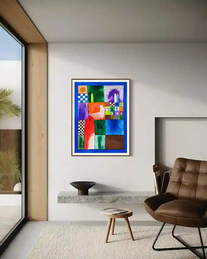 "Memory Quilt" art print by Abushariaa Ahmed framed above leather chair in modern living room with window