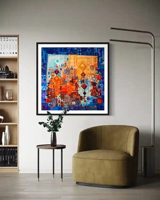 Framed Nubian Doors 4 abstract artwork in blue and orange tones displayed above olive green chair and side table.