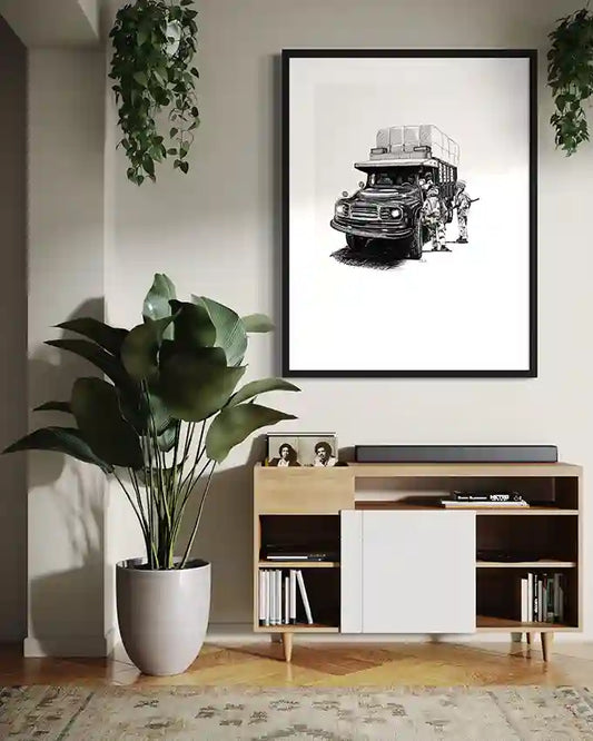 The Stop art print by Obada Gabir displayed in black frame above modern credenza with large plants and books in contemporary living room