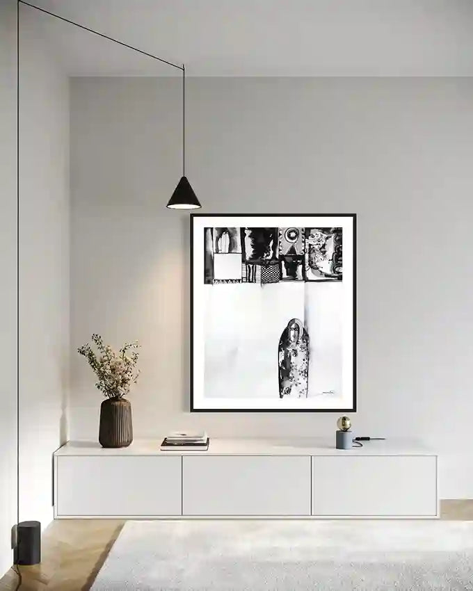 "Patterned Solitude" art print by Abushariaa Ahmed displayed above white console with pendant light in minimalist room