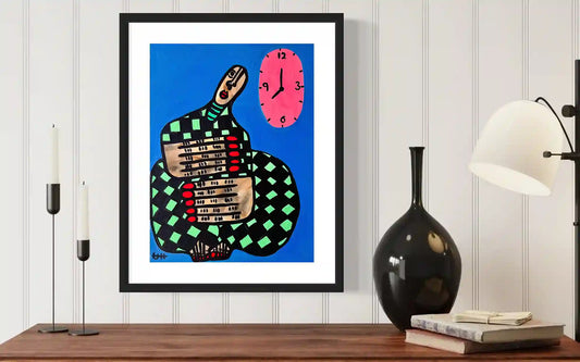 Stillness by Usra Hamza framed art mockup on wall with modern decor, showing figure with clock in vibrant blue composition