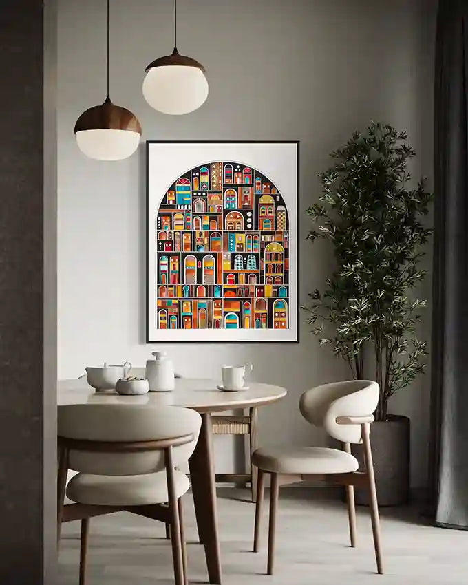 Dining room with a framed art print by Artist Yousif Ibrahim of arches piece on the wall, table, and chairs. in UAE