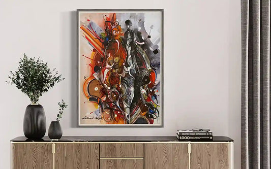 Duality by Mohamed Wraag in silver frame above wood credenza, mixed media art with contrasting orange and black split design