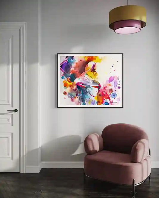 Colorful large abstract art print by Sudanese artist Galal Yousif on a wall above a pink armchair with a modern light fixture