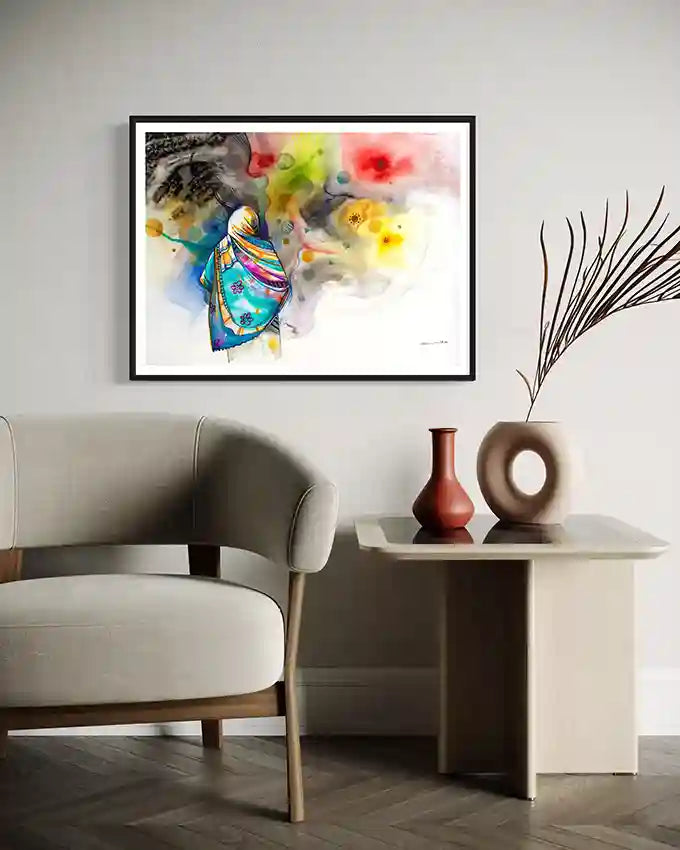 Framed art print By Sudanese Artist Galal Yousif size 100x74 cm on a wall above a sofa with decorative vases on a table.UAE