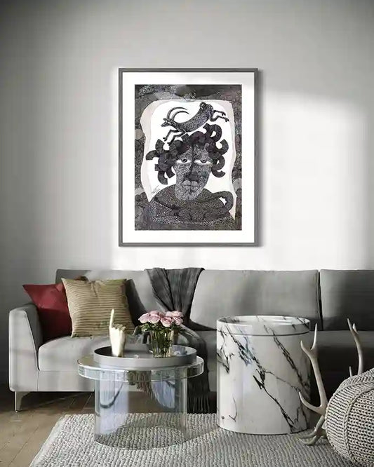 "The Storyteller" art print displayed above modern gray sofa with colorful pillows and marble coffee table.