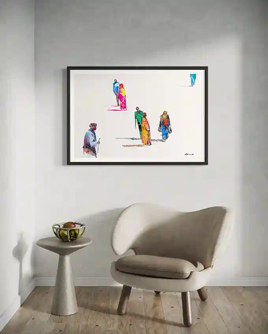 Framed Art print of abstracted people on a wall above a beige chair and small table. by visual Artist Galal Yousif, in UAE