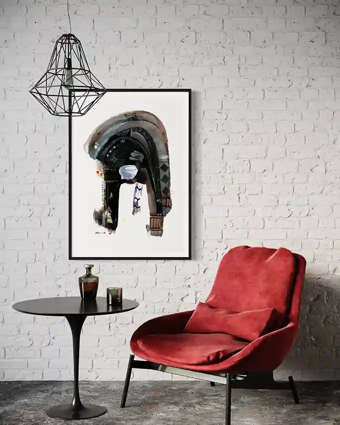 Red armchair in a room with a white brick wall, black table, & framed art print by artist Galal Yousif, in UAE