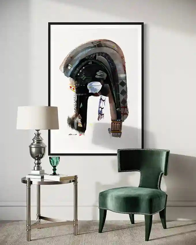 Modern interior with a green chair, side table, and framed art  print on the wall by artist Galal Yousif, in UAE and abroad 