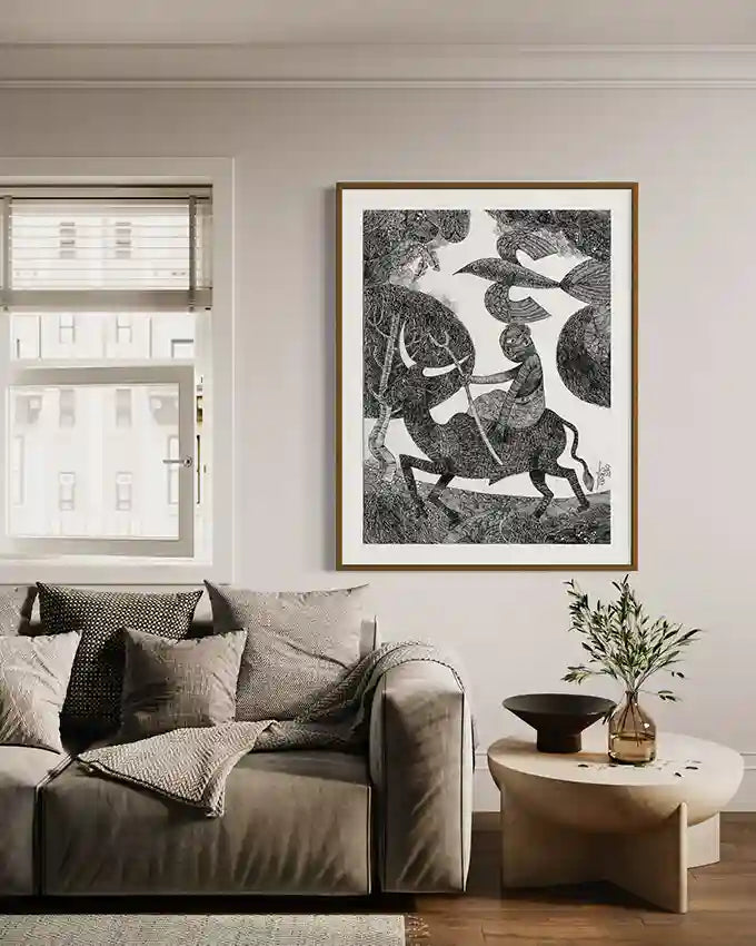 "Carved In Ink" art print by Tariq Nasre displayed in cozy living room with gray sofa, wooden coffee table, and plants