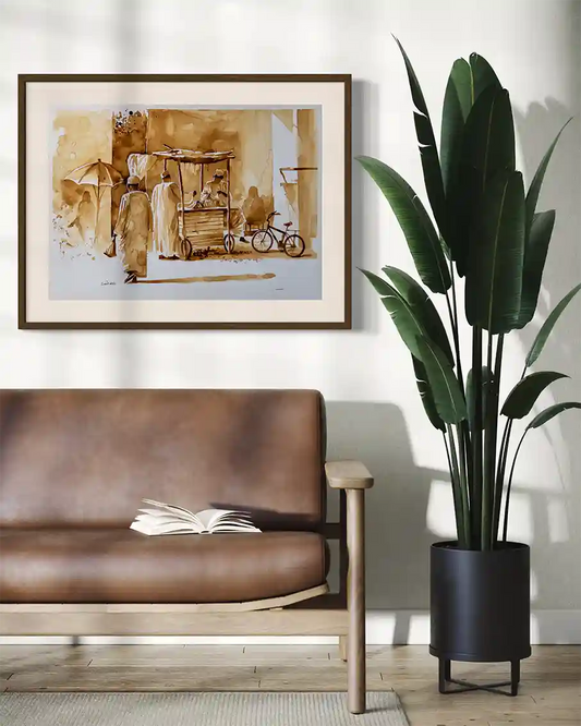 Coffee Chronicles Market Scene art print by Salih Abdo in wooden frame mockup on living room wall with leather sofa