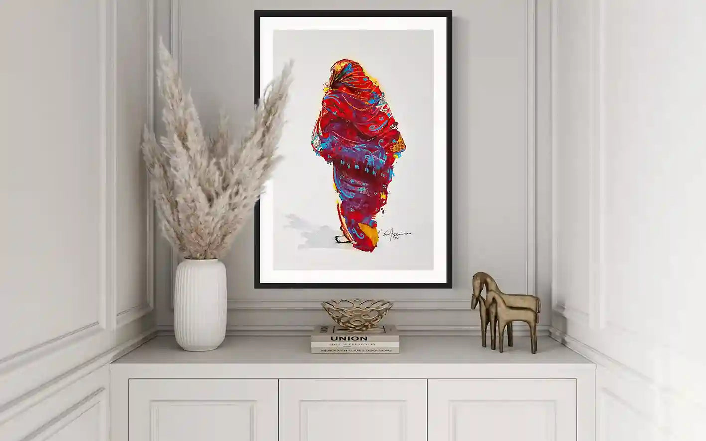 Daughters of the Nile 1 art print by Yasir Algrai displayed in black frame on white sideboard, elegant home decor mockup