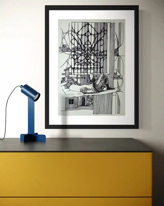 Feed Your Mind framed original artwork by Obada Gabir displayed above yellow desk with blue lamp showing home decor styling