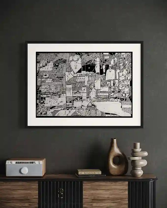Framed "Fragments of Memory" art print by Osman Gouma displayed on dark wall above wooden console with decorative objects
