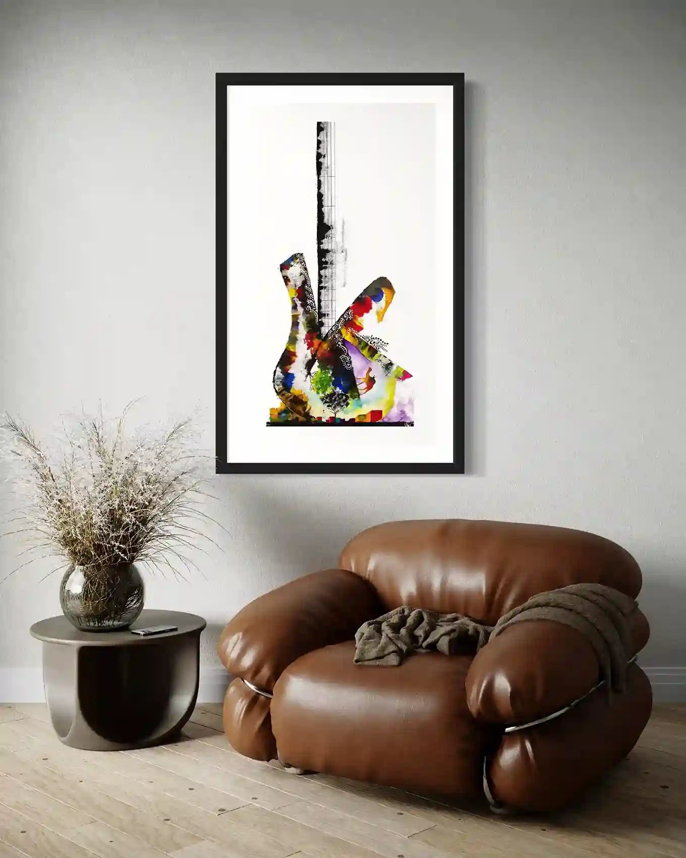 Guitar by Gungalito framed print above leather chair - colorful watercolor guitar art in modern minimalist living room