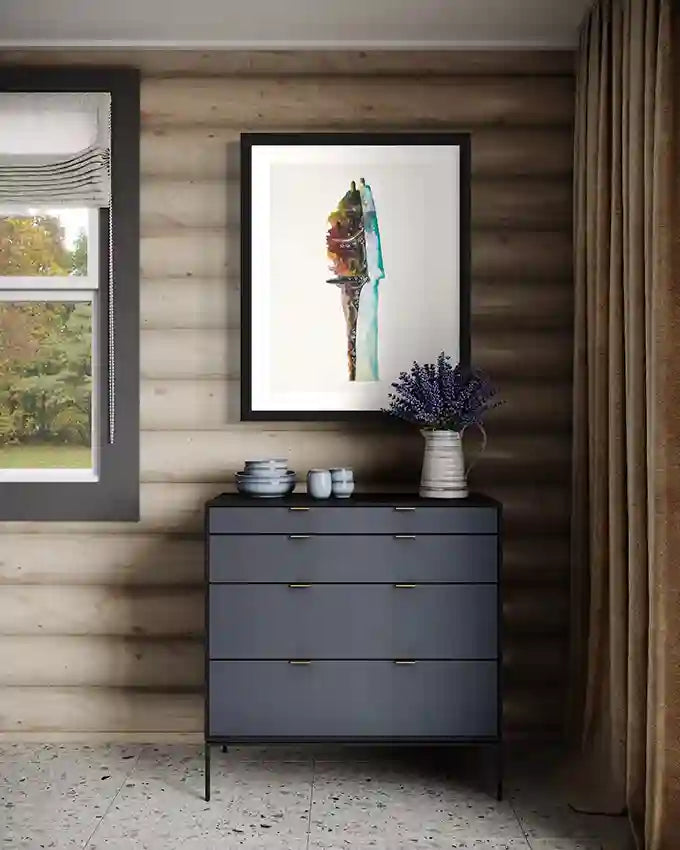 'just-married' art print of husband and wife by artist Yousif Ibrahim framed on a wall  above a side table, in UAE