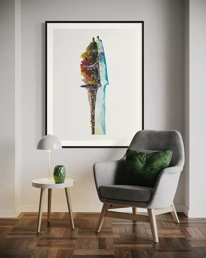 Modern interior with a grey armchair, small round table, and art print 'just married' on the wall. by artist Yousif Ibrahim 