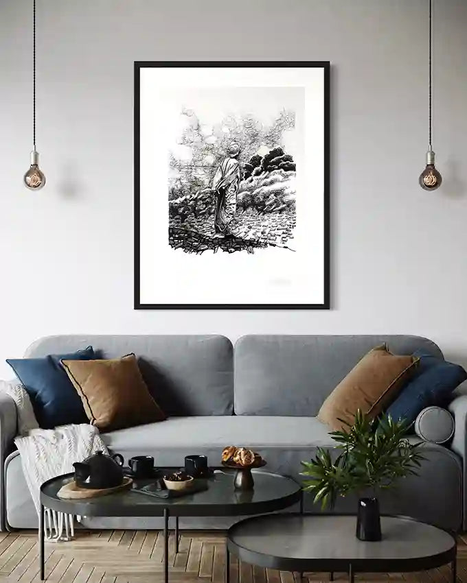 Obada Gabir Contemplation pen and ink art print in black frame displayed above gray sectional sofa with pendant lights and coffee table in modern living room