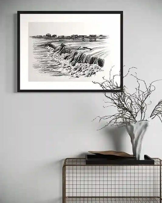 Obada Gabir waterfall pen and ink art print displayed in black frame on white wall above modern console table with vase and branches