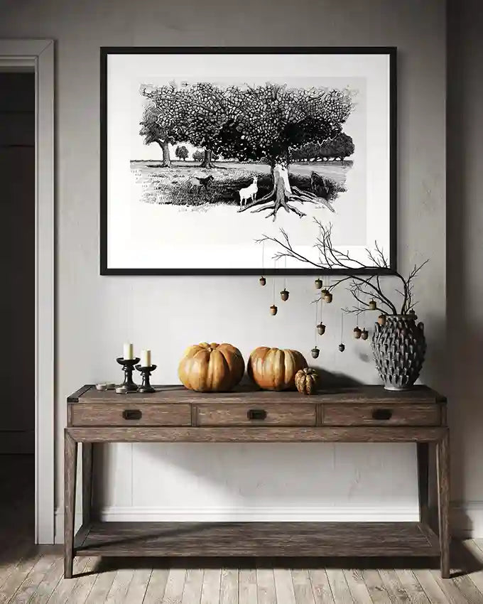 Pastoral Refuge black white art print by Obada Gabir in black frame above rustic wood console with autumn pumpkin decor