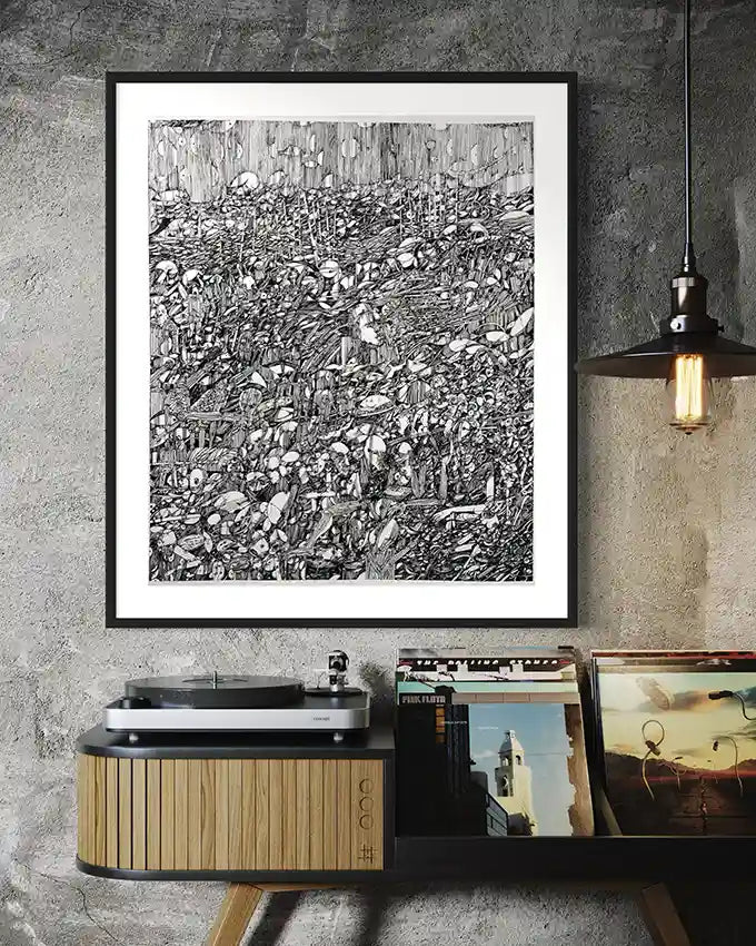 Framed ‘Secret Garden of Ash’ black and white art print piece on a concrete wall with vinyl records below.
