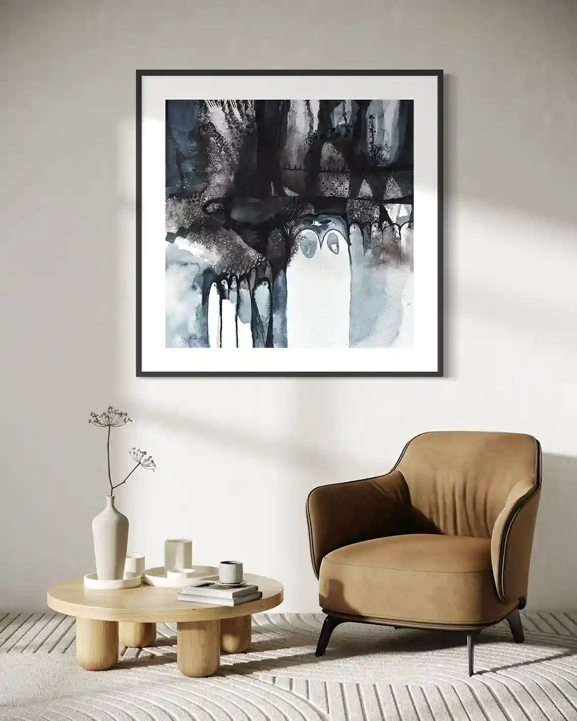 Shadow Play framed art print by Abushariaa Ahmed displayed above tan leather chair in minimalist living room