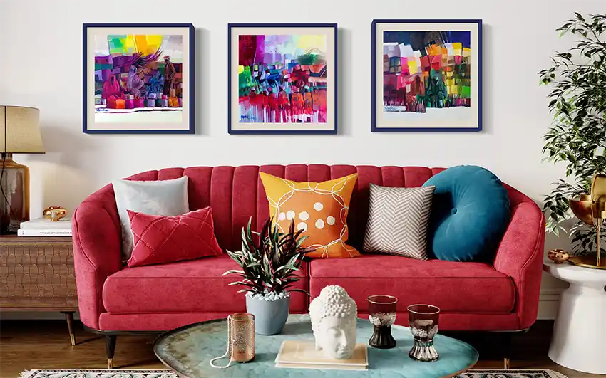 The Space Between Us art print displayed as center piece in triptych gallery wall above red velvet sofa in living room
